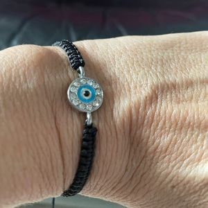 Black rope tie closure. Evil eye center